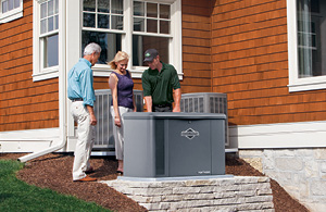 Couple talking to Meenan tech looking at generator