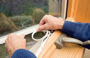 Person insulating their windows