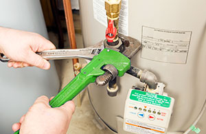 Using 2 wrenches to fix water heater