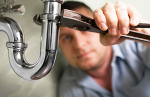 Plumber fixing sink