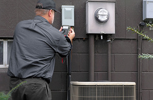 Service tech checking meter