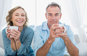 Smiling couple drinking coffee