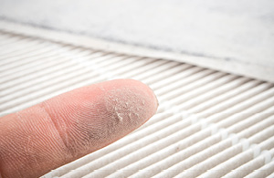 Finger with dust from HVAC filter