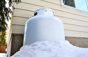 Propane tank covered in snow