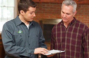 ai_replacefurnace_1 Meenan tech reviewing invoice with customer