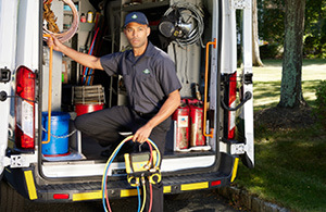 Service tech in front of van