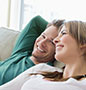 Couple smiling on sofa