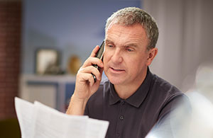 Man on phone reviewing bill