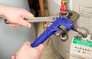 Using wrenches to fix water heater