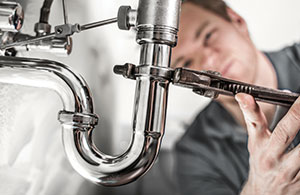 Plumber fixing sink